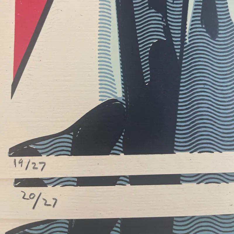 Close-up of two numbered art prints signed and dated as 19/27 and 20/27.