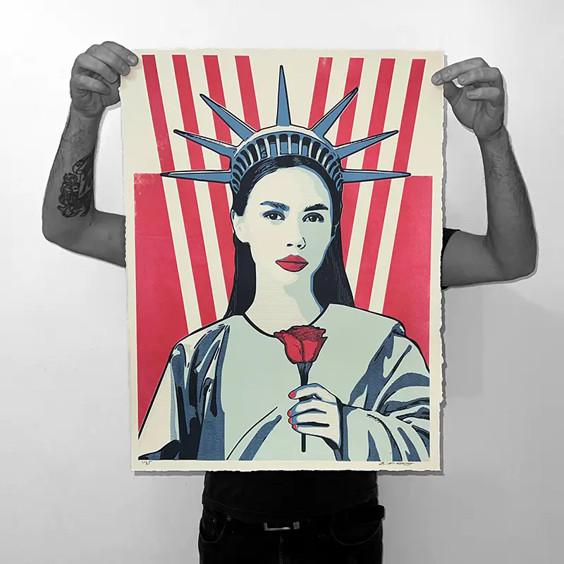 Person holding a Statue of Liberty poster with a red rose and rays background.